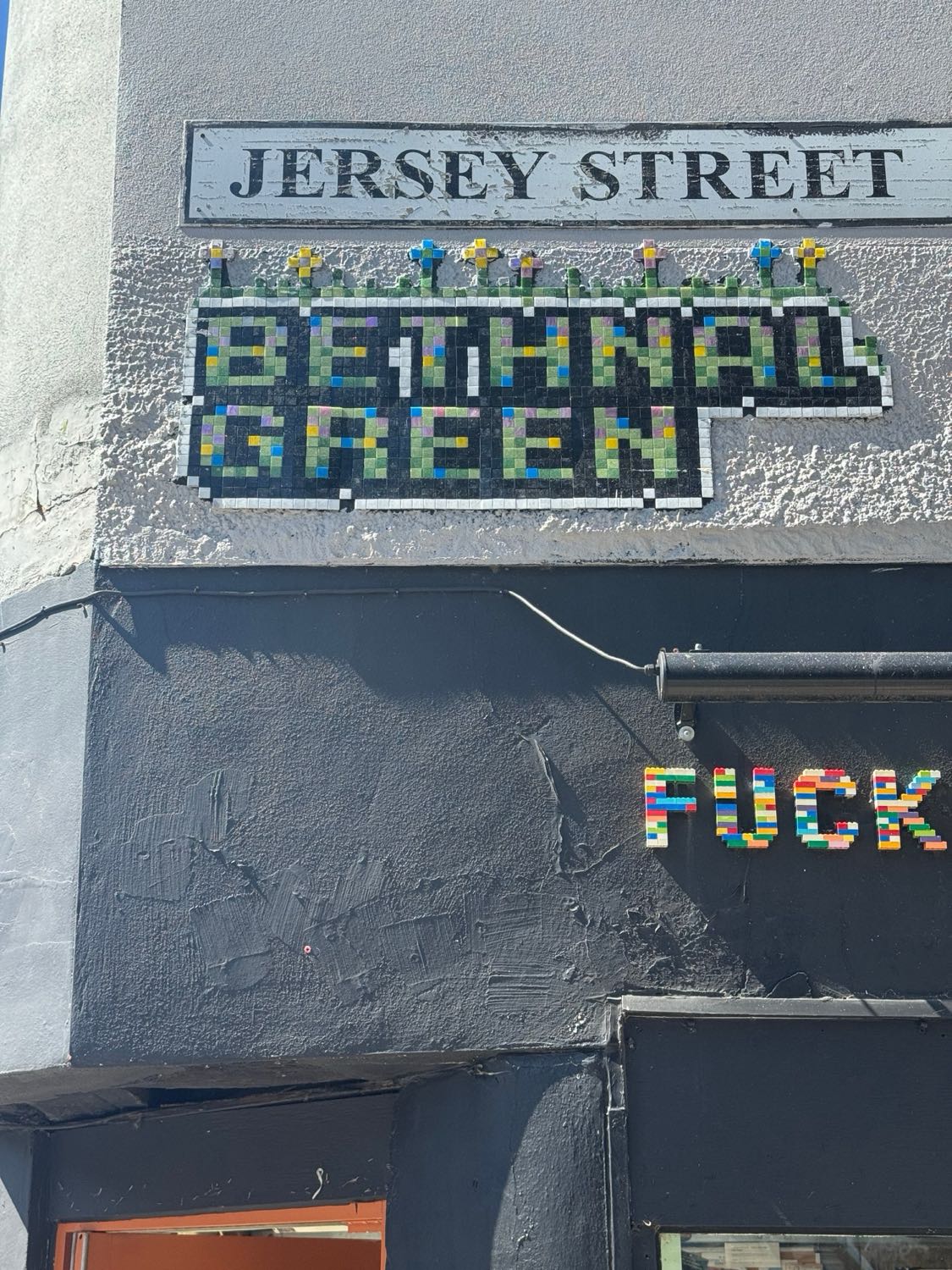 Jersey Street / Side of 'Fuckoffee' mosaic artwork in London